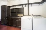 Laundry room with washer, dryer, microwave, and second refrigerator